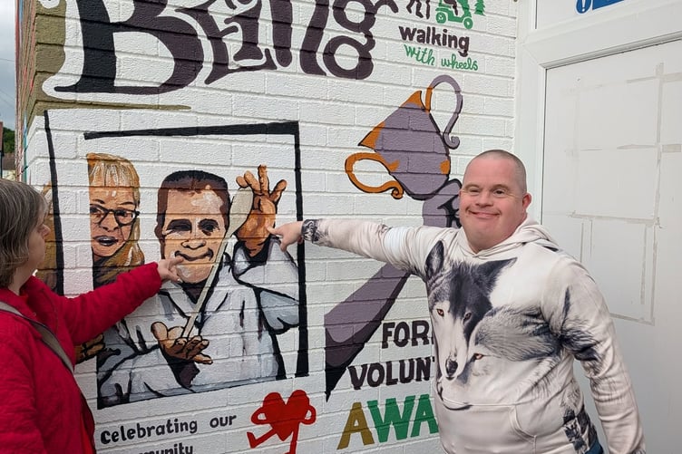 George, a volunteer with the Newent Sharing Kitchen, is one of the faces on the mural.