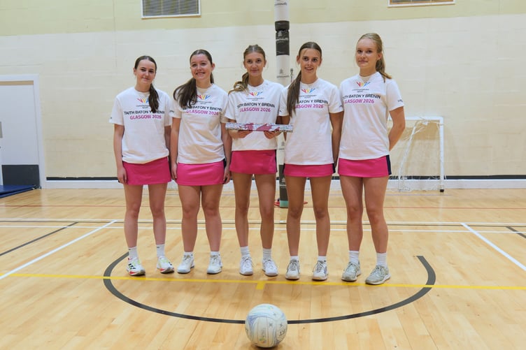 The netball !st team with the King's Baton