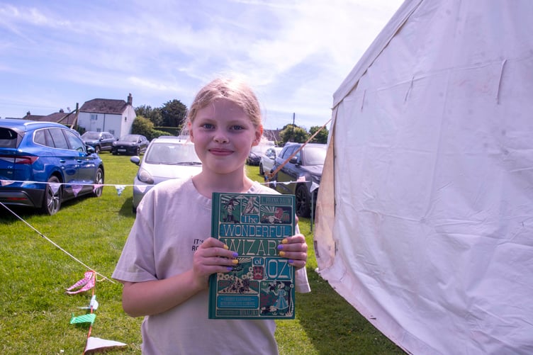 Polly-Mae Walker with her “spirit of the carnival” prize for taking such care with her handwriting when filling out her entry for the village scarecrow competition.