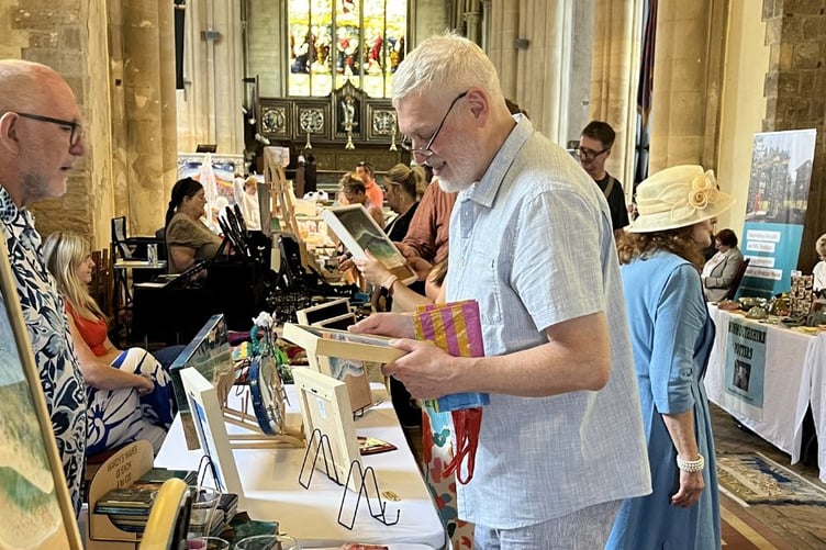 Welsh artists and crafts people display and sell their creations in the stunning backdrop of St Mary's Priory