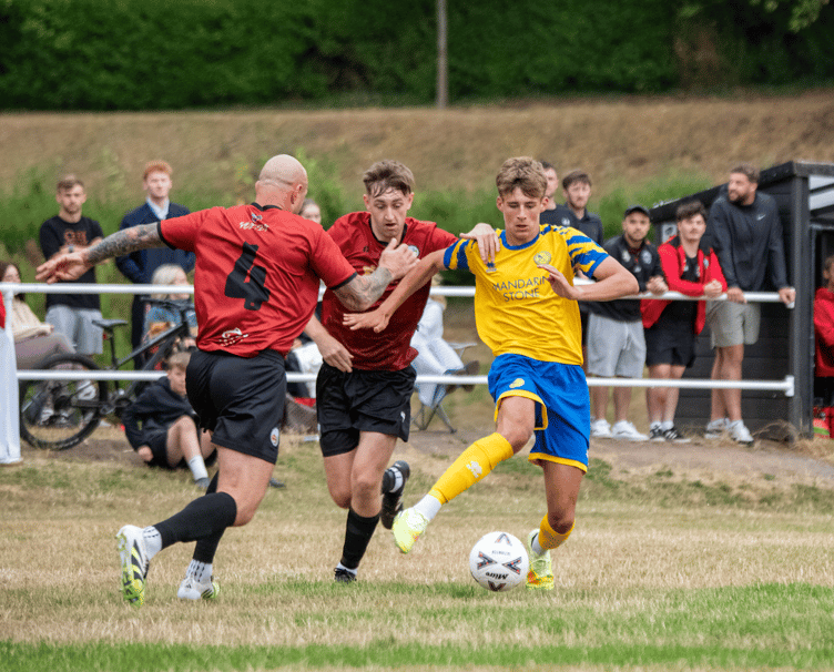 A Monmouth player shrugs off the attentions of two Brynmawr players in the midweek cup win. Photo: James Townley